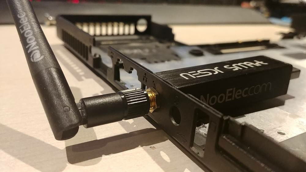 The early fitting of the components : 
In here, there's the SDR (witch fits perfectly through the 3.5mm jack ! made to be !) the Pi and (although hidden) the SSD.
I also had to cut the frame a bit to fit some stuff. The pi is slightly too tall, but the buldge is not toooo bad.
