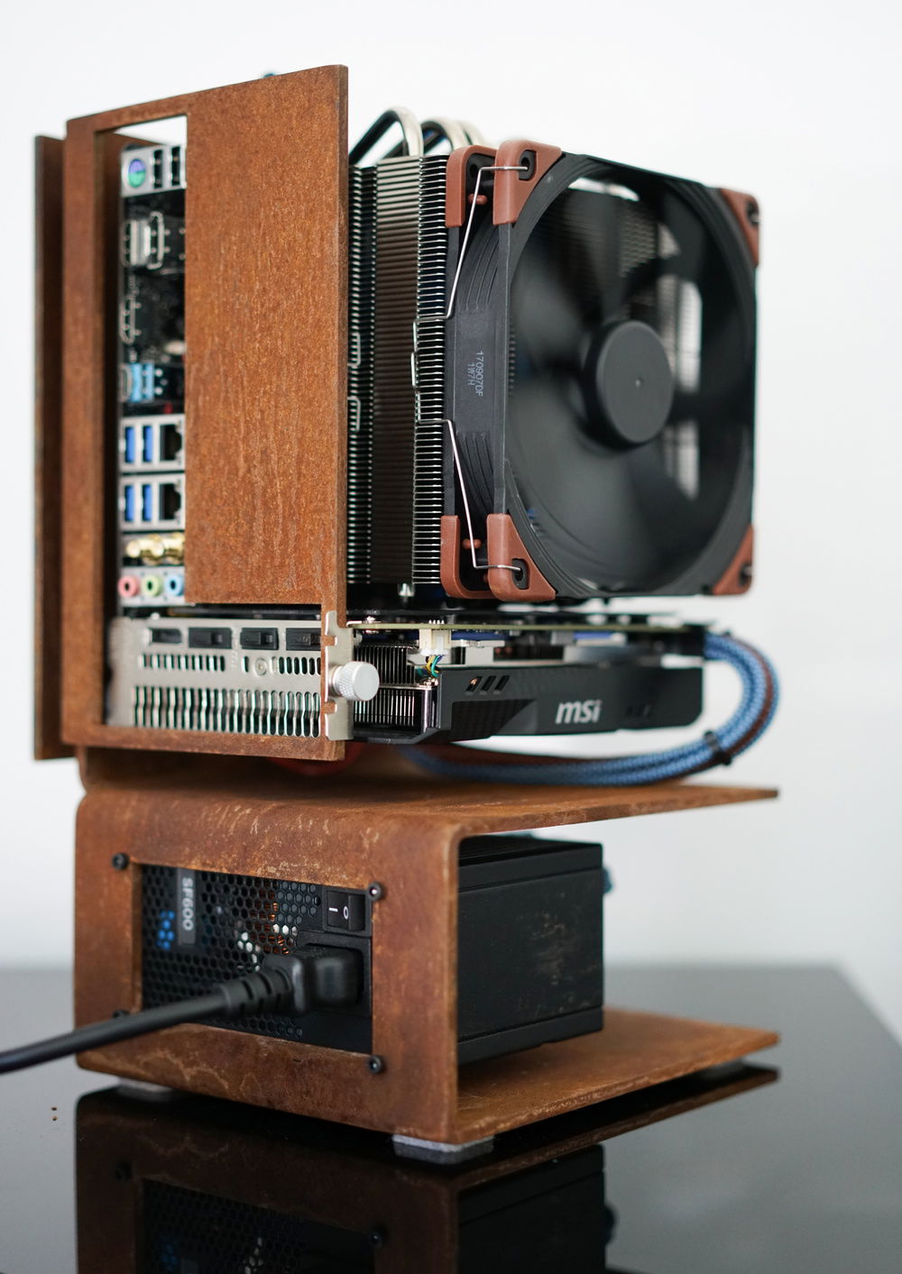 Leaving the motherboard IO plate off was a great idea. Enhances the industrial look and there is plenty of air flow out through that area.