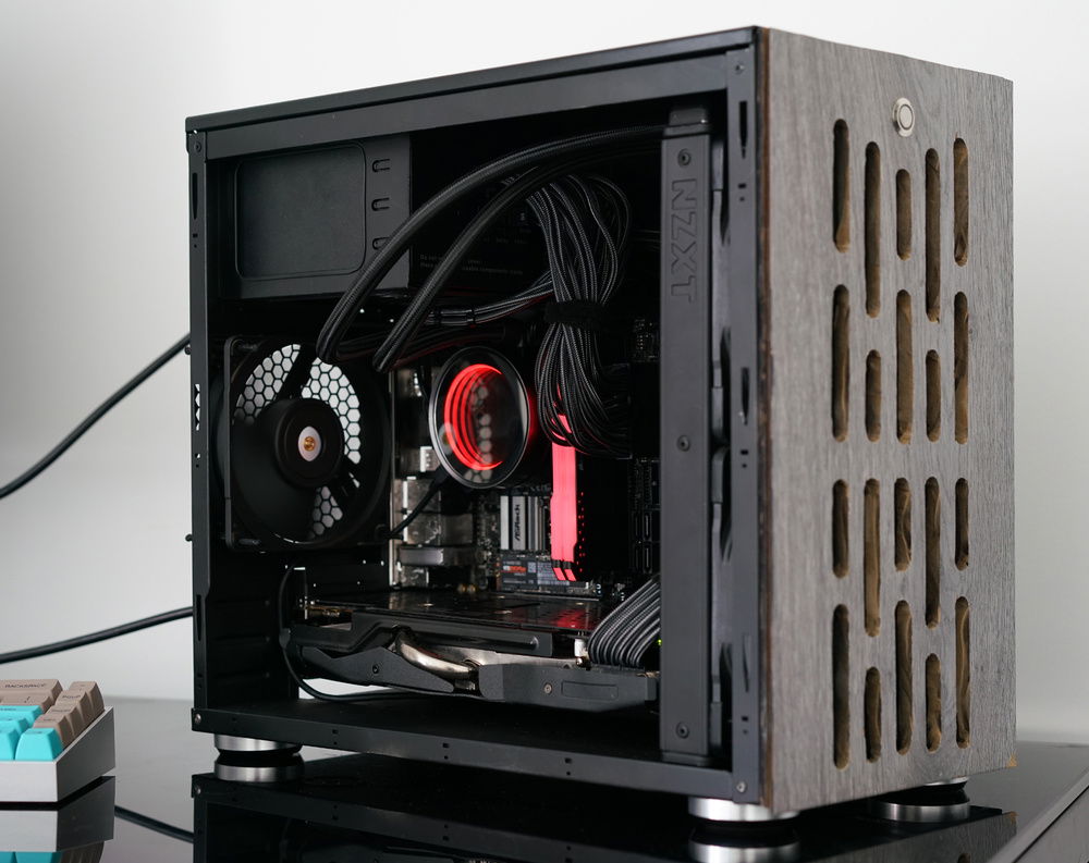 I got some new case feet to lift it off the desk and a new button for the on off switch. The front panel is a floorboard that I hand cut the air vents with a dremel. My original plan was to spray this black as well, but I've been asked to leave it grey. The PSU is an EVGA 650w G3 Supernova gold top mounted.