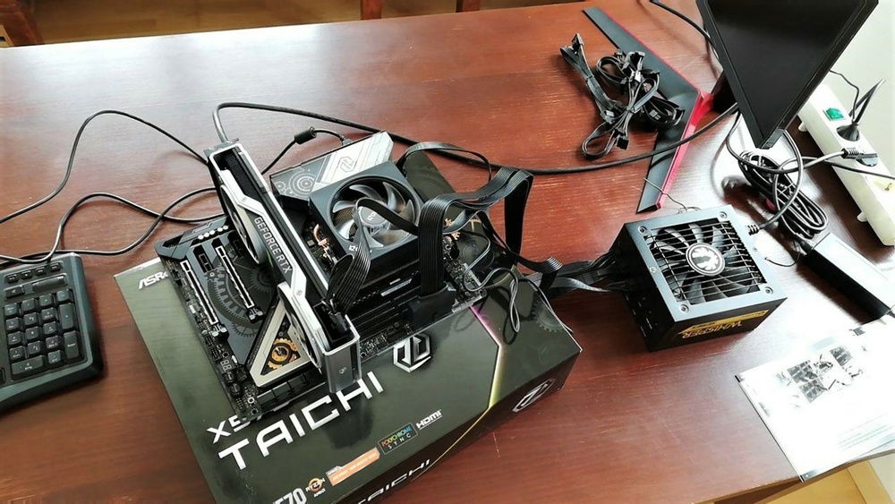 Took Linus's advice and built everything outside first. As expected, it didn't POST.

Thankfully, the X570 TaiChi has debug LEDs - turned out that the GPU wasn't plugged in all the way.

Rookie mistake, but pretty easy to fix. Could have been worse...