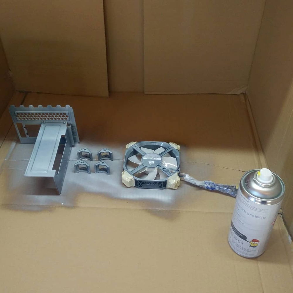 9th April 2020: Once the "GummiDip" was here, I searched the house for some masking tape and spent the evening masking off the rubber corners of one of the ML120 fans. I also masked the gap between the fan frame and the rotor so that paint wouldn't get in there and ruin the electronics.

Then I used the box that I received the MoBo and fans in as a little spraying shroud and got to work.