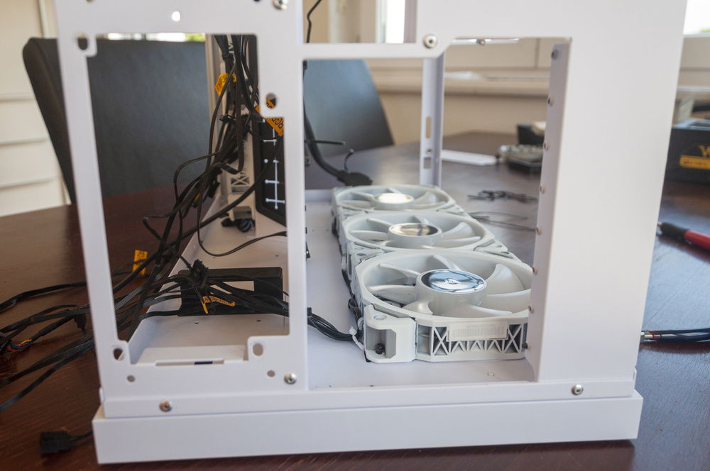 The bottom fans needed to be done first. This could be a bit of a permanent setup since they won't be removed even after the system is watercooled. I used the fans themselves to lightly clamp the cables down and used cable twisties to secure the cables to the case.