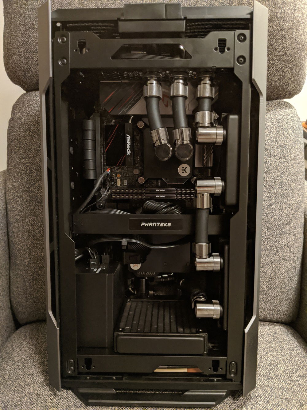 Cables installed and "managed". Nothing to write home about, but not going to bother until I get custom cables later. Under the back panel is a corsair commander pro. Its driving the three fans and is hooked up to an inline water temp sensor. Eventually I'm going to use it for a couple of LED strips to light up the interior. 
Now, I'm waiting for the pump. I actually have 3 of them ordered, and I don't have an ETA for any of them :(