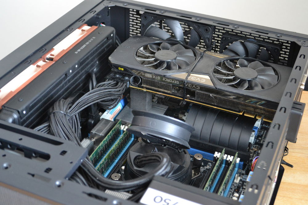 We can see all the fans here.
Two A12x25's pushing air in through the rad, the cryorig VRM cooler helps push air to the top and then the A12x15 and A9x14 push the air out the top. 
The GPU has an intake on the sidepanel but it still gets a bit toasty sometimes. Old photo.