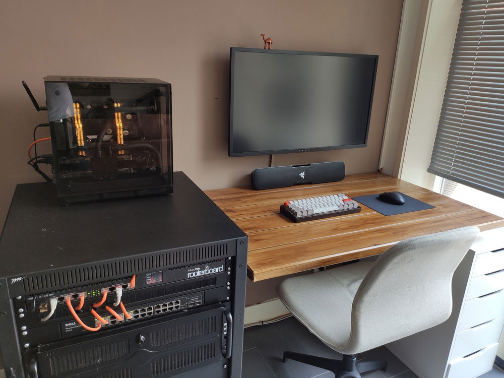 The setup as she now stands. To the left is my rack with the networking stuff and a distributed computing server