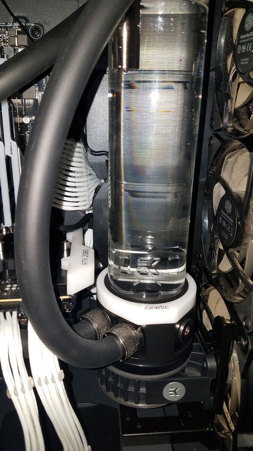 A close look at the ugly tubing run I had to use before adding the additonal fittings and components that cleaned it all up, and thankfully those dirty fans are gone as well.  They didnt move too much air through this radiator so the system got pretty warm before adding the new Vardar fans.