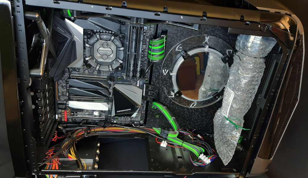 Mainboard in, with cover, fans, radiators, and reservoir