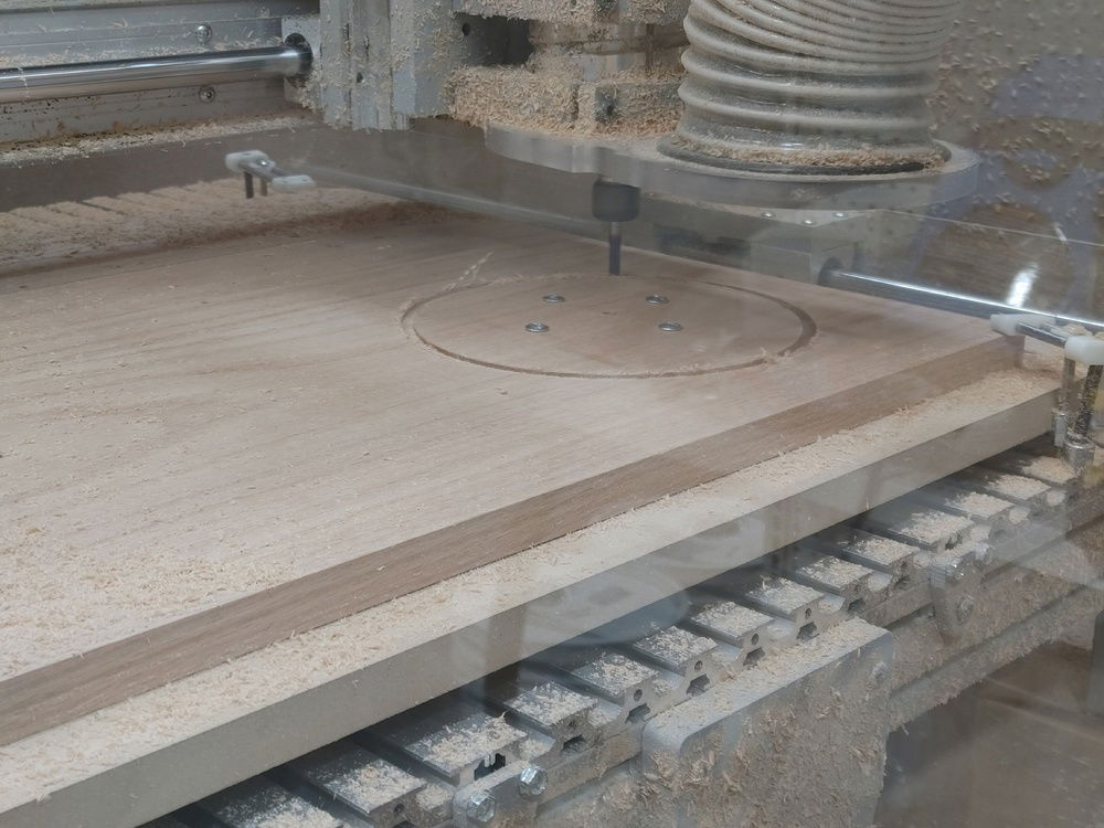 Cutting out the fan hole. Screwed down to the spoil board so it could be cut out without using tabs. Nice!