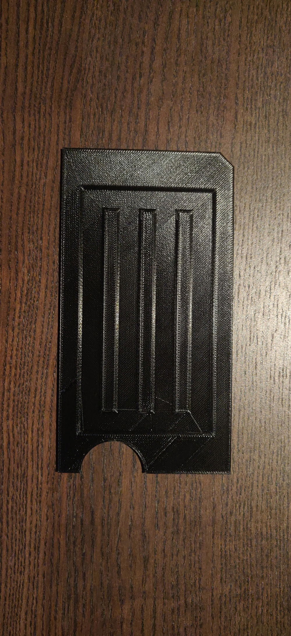 The piece I designed and 3d printed to attach to the existing power supply and hide the cables that the removed hard drive cage used to hide.