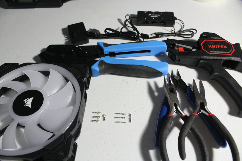 Tools and materials to make corsair LL fans modular by cutting, stripping, and re-crimping their corresponding terminals.