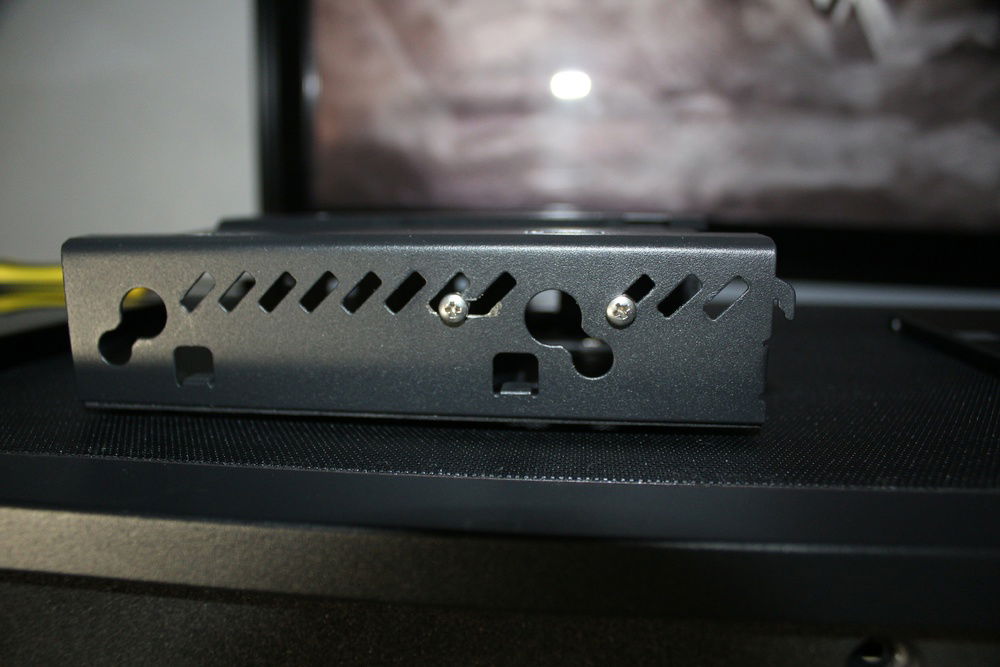 With a dremel, made space for the monitor mount screws used to keep it in place while attached to the drive cages.