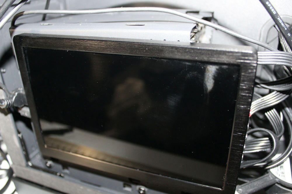 Monitor and cages placed in their corresponding locations within the chassis.