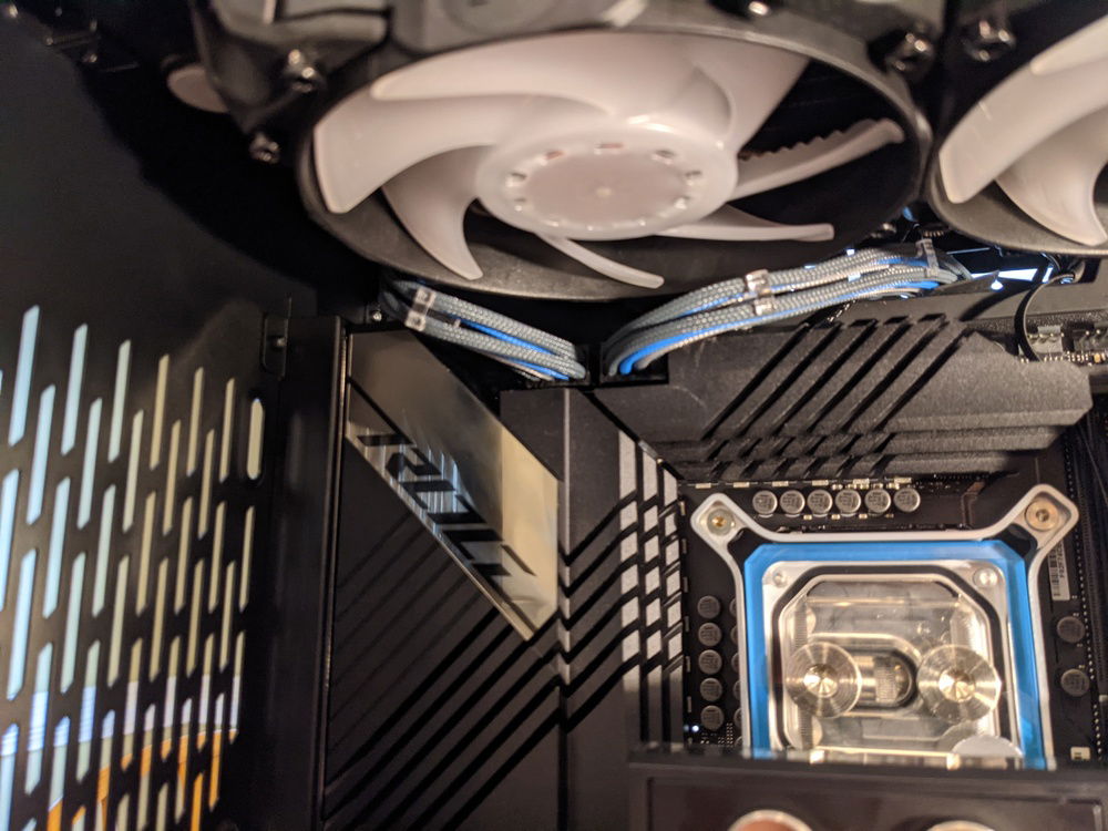 Alternative way to feed the two EPS cables to the back of the case to give more clearance for tubes