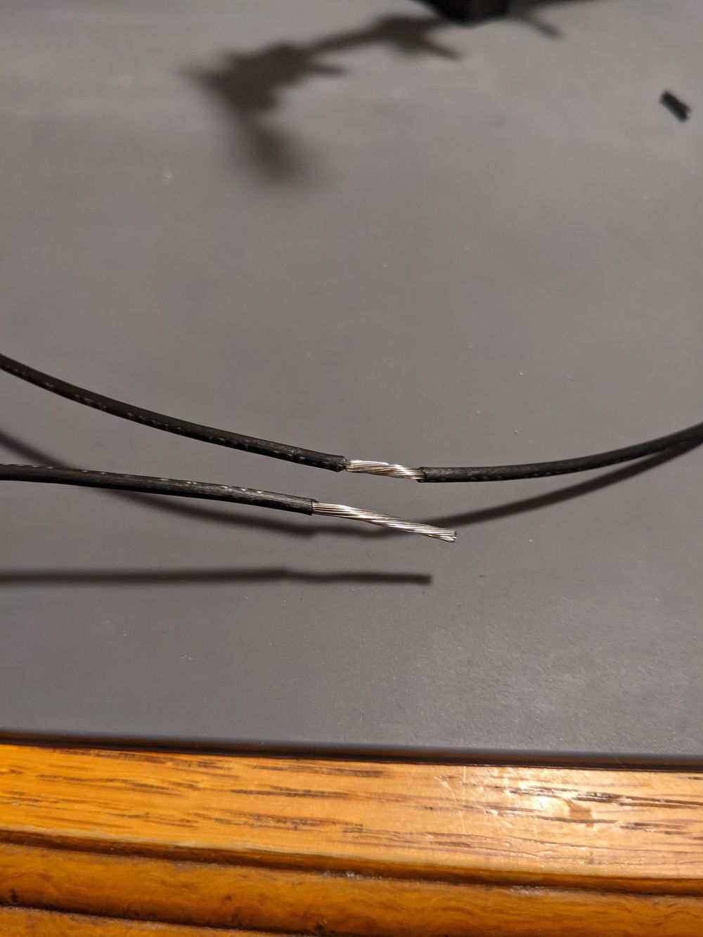 Preparing to splice the wires together. To get a good mechanical connection prior to soldering, I stripped about twice the insolation from the joining wire than I did from the main wire.