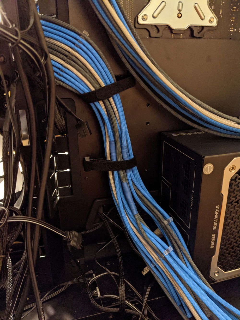 To measure where I needed to cut the wires, I put cable combs on the ends with the wires in the same positions they would be inside the connector. I then put the cable in the case and moved the comb around until it had just enough length to reach the appropriate PSU socket, and cut the wires about an inch or so after that cable comb.