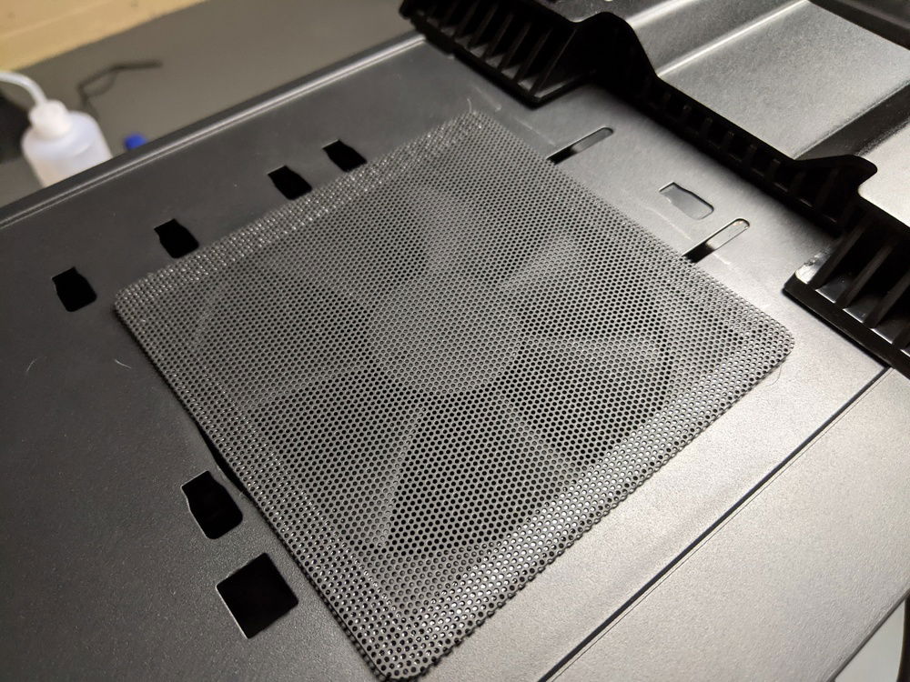 Got trigger happy with the Dremel and added a fan on the bottom of the case, positioned right under the pump/res.