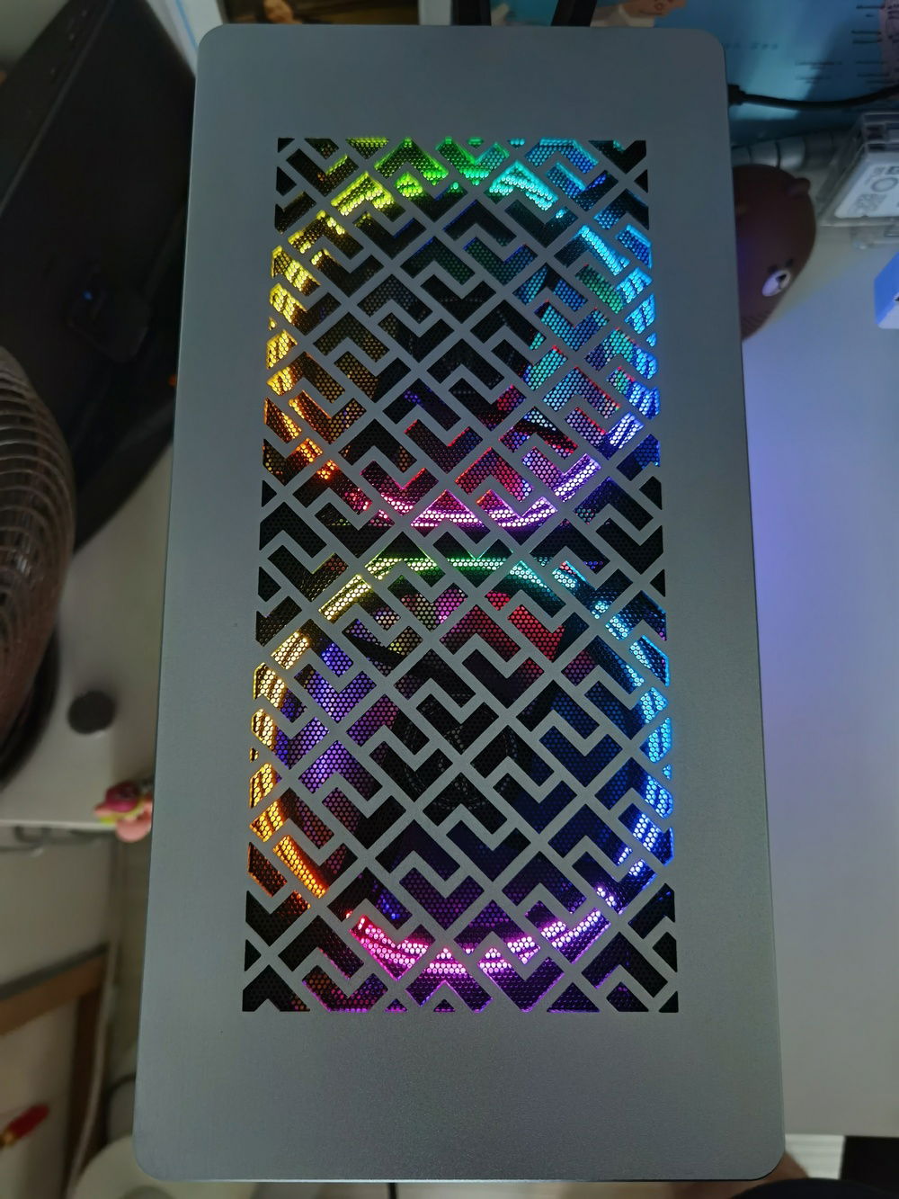 Laser cut top panel showing the double-ringed RGB fans