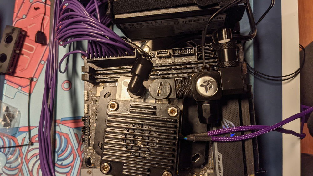 Had to get creative with the fittings to route tubes between mobo and psu.