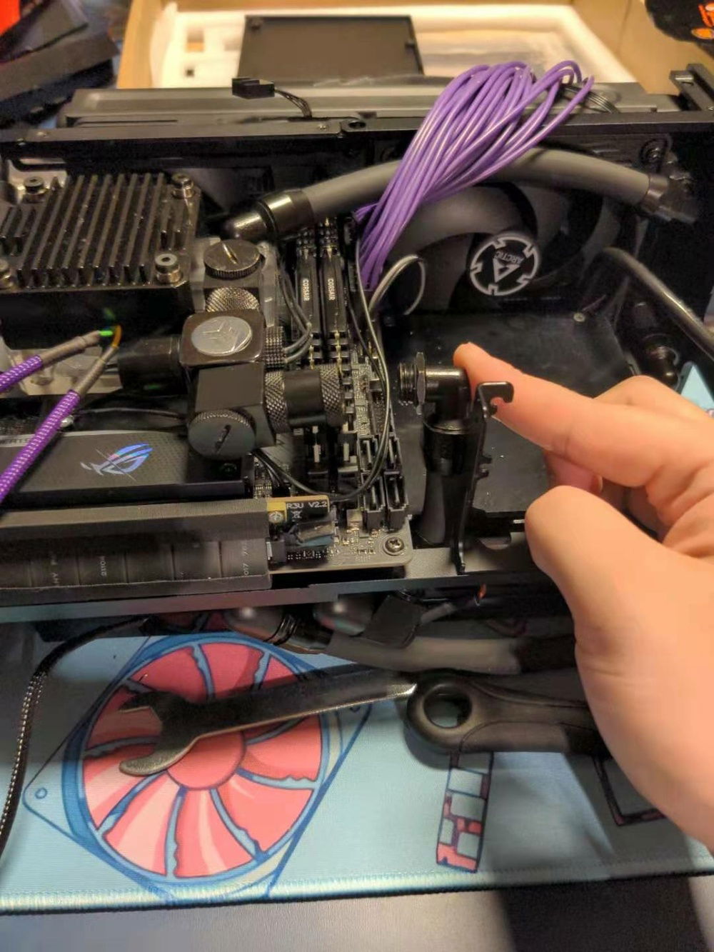 The Alphacool TPV tube is just skinny enough to fit in this little hole toward the bottom of the case.