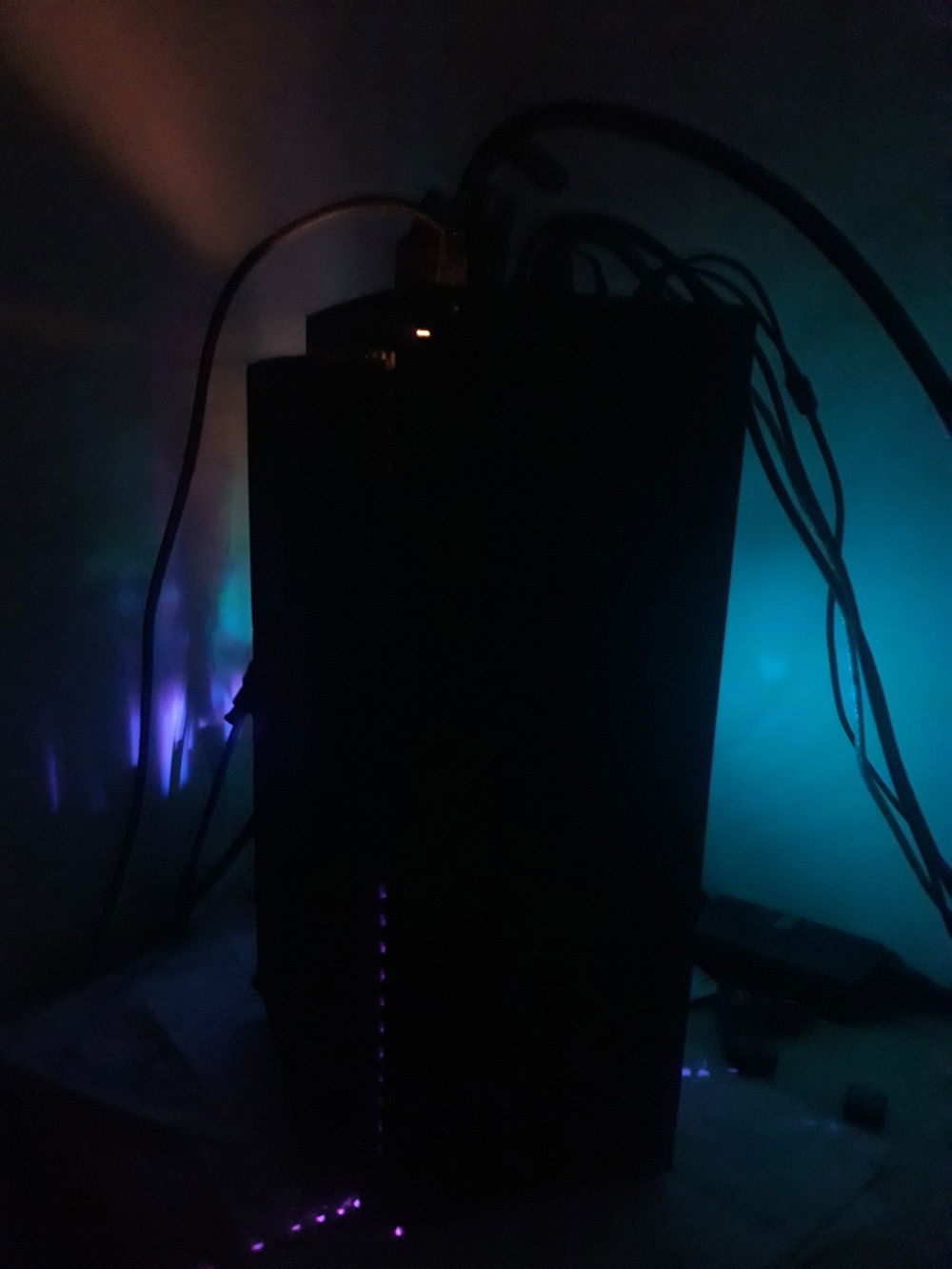 Front and the fan side in a dark room showing the rgb.   cables coming from the top sure look messy