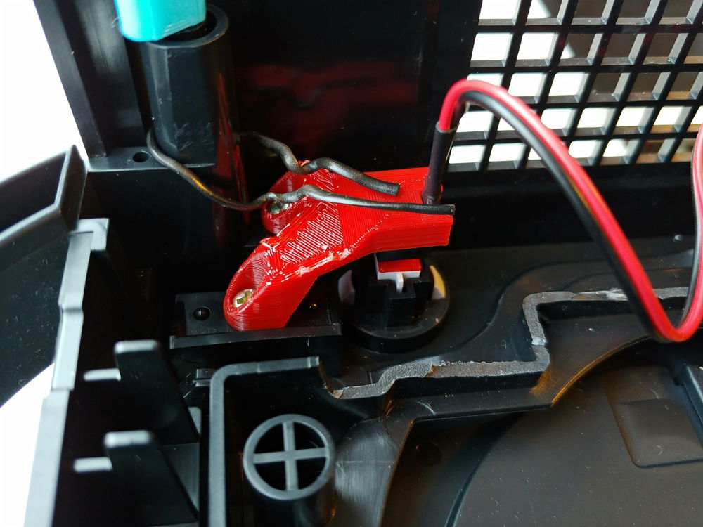 I had to replace the original power button with a smaller power button due to size constraints. This 3D printed bracket holds the button in place, plus adapts the button to the bigger case-button.