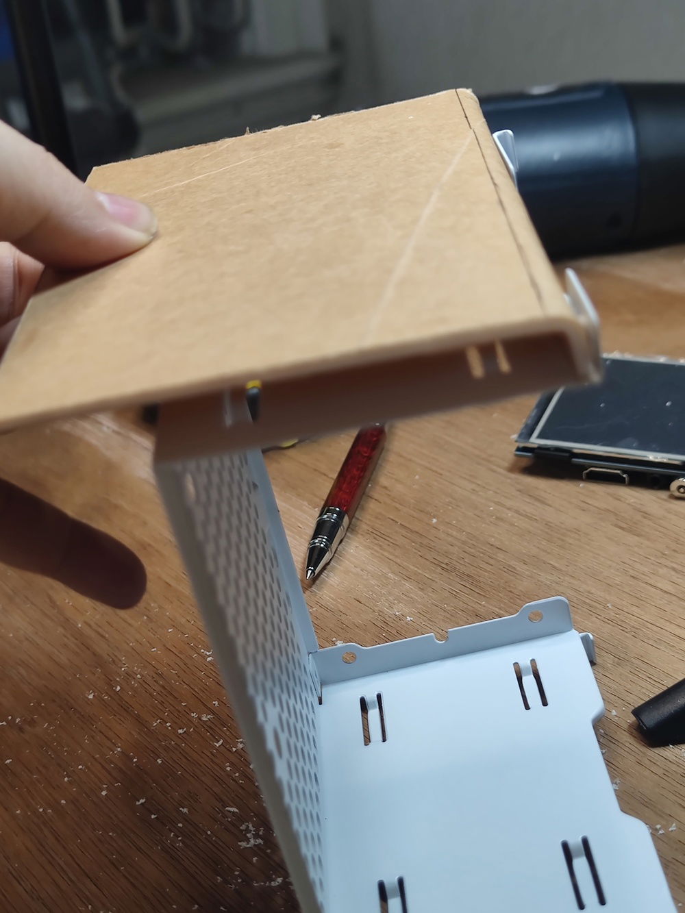 The fold in the acrylic was designed to become an anchor point when I screwed the whole PSU cage assembly onto the front of the case. One screw would hold both the cage and the shroud while creating space for the thickness of the LCD.