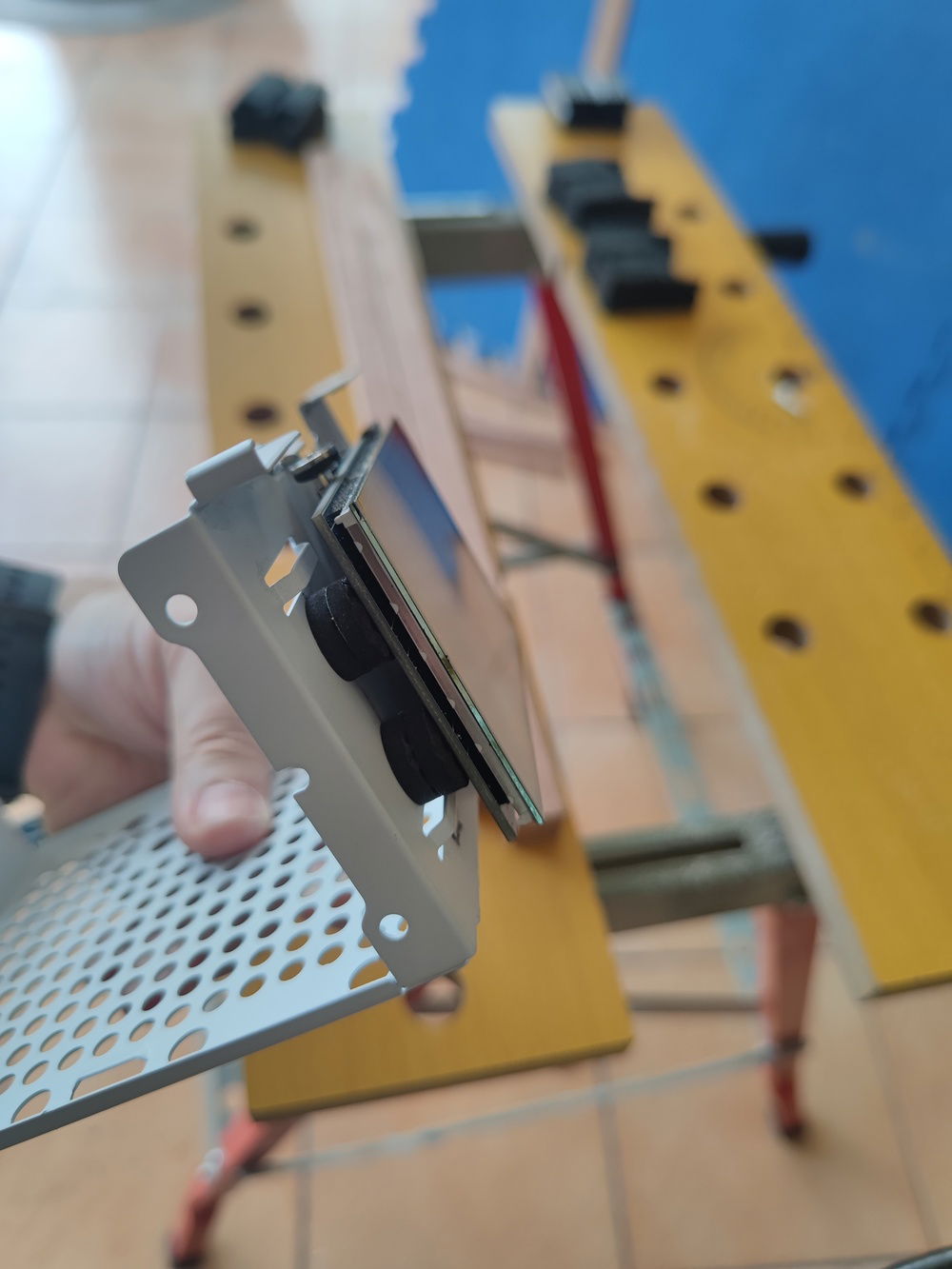 The other side of the LCD is propped up using rubber mounts to keep the LCD level.