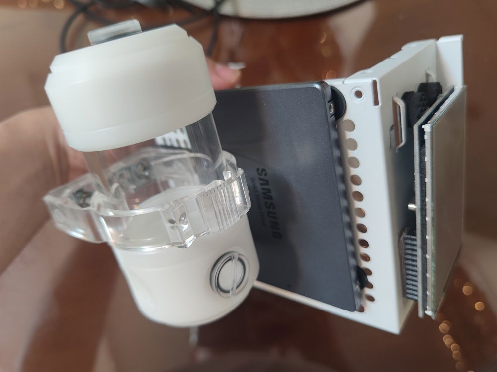 I decided to mount the SSD to the PSU cage to save space (also because all of the wiring is hidden in the front section of the enclosure, taking up the existing front mounts for SSDs). The sideway mount for the reservoir is required to clear the motherboard ATX power cables and create more room for airflow from the side mounted intake fan.