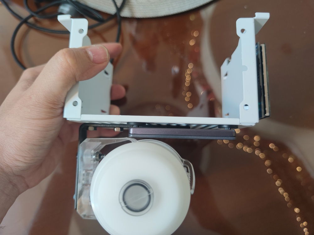 I have barely half a millimeter of clearance between SSD and reservoir. Not that I have to worry about vibration with a non mechanical storage device.