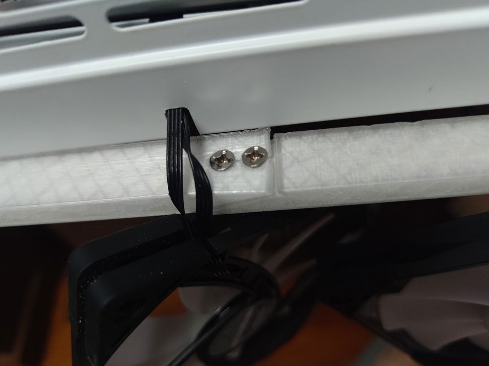 The riser hides the fans from view (unless you really peek under the case) as well as the cables leading into the case.