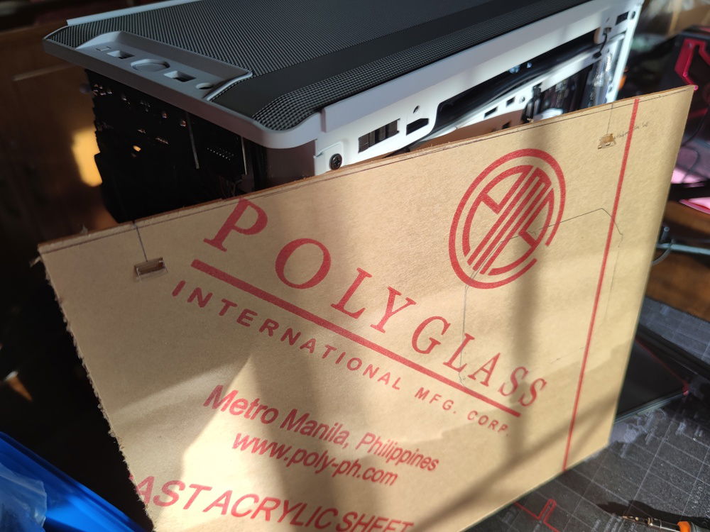 I cut and glued some tabs that lined up with the NR200's slots onto the acrylic panel to hold it up when installed.