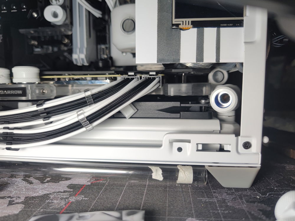 The bottom radiator clearance is more of the same. Some fan frame material had to be cut away (same with the Noctuas that replaced the fans in this pic) to clear the fitting and tubing.