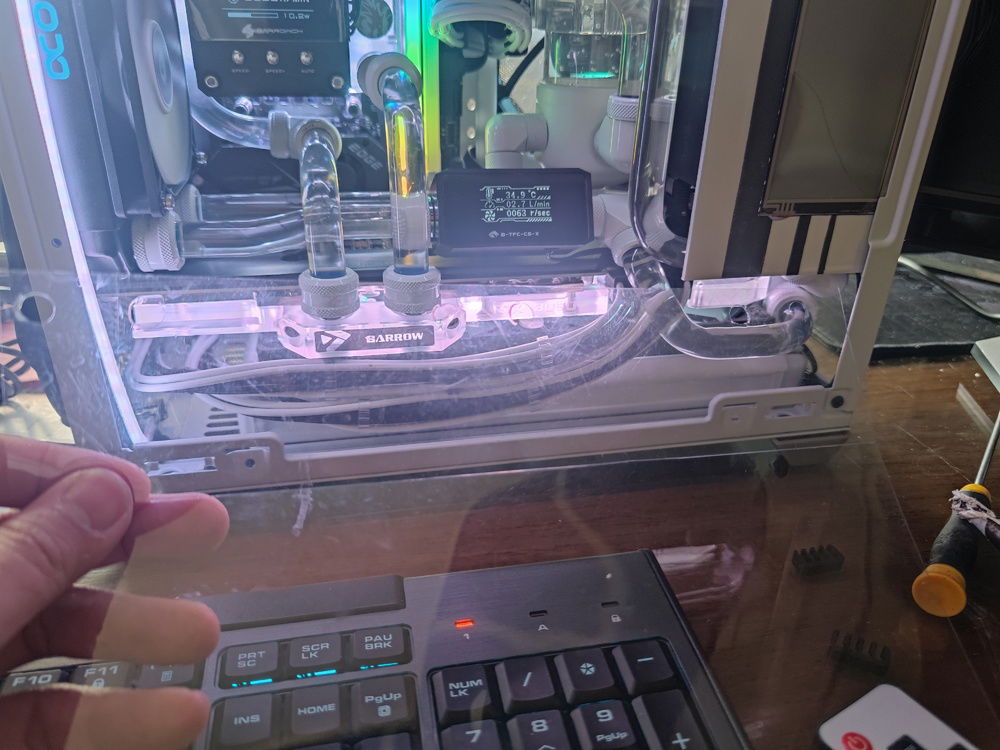 This piece of plastic was cut to size to sit on top of the GPU backplate, protecting it from small drips from any of the components above it