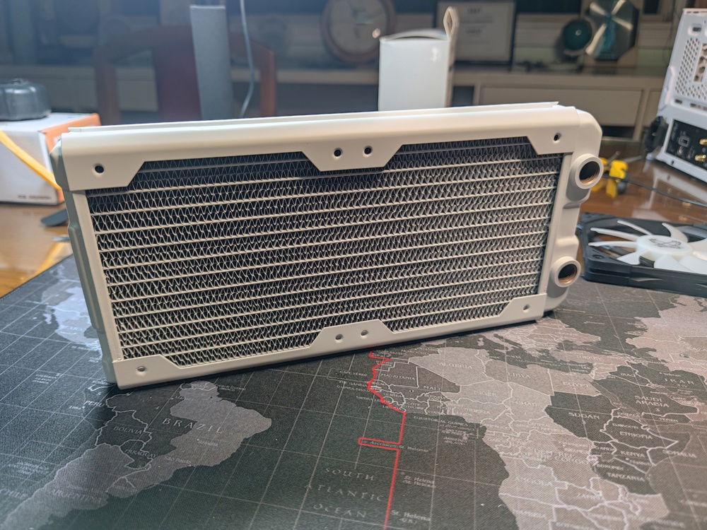I chose the cooling components based on cooling performance, so I naturally ended up with the excellent Hardware Labs Nemesis series. 

While not exactly slim, at 29.6mm thich, it was slim enough to be able to fit high performance 15mm thich fans from Noctua on top and still clear the GPU water block with space to spare.
