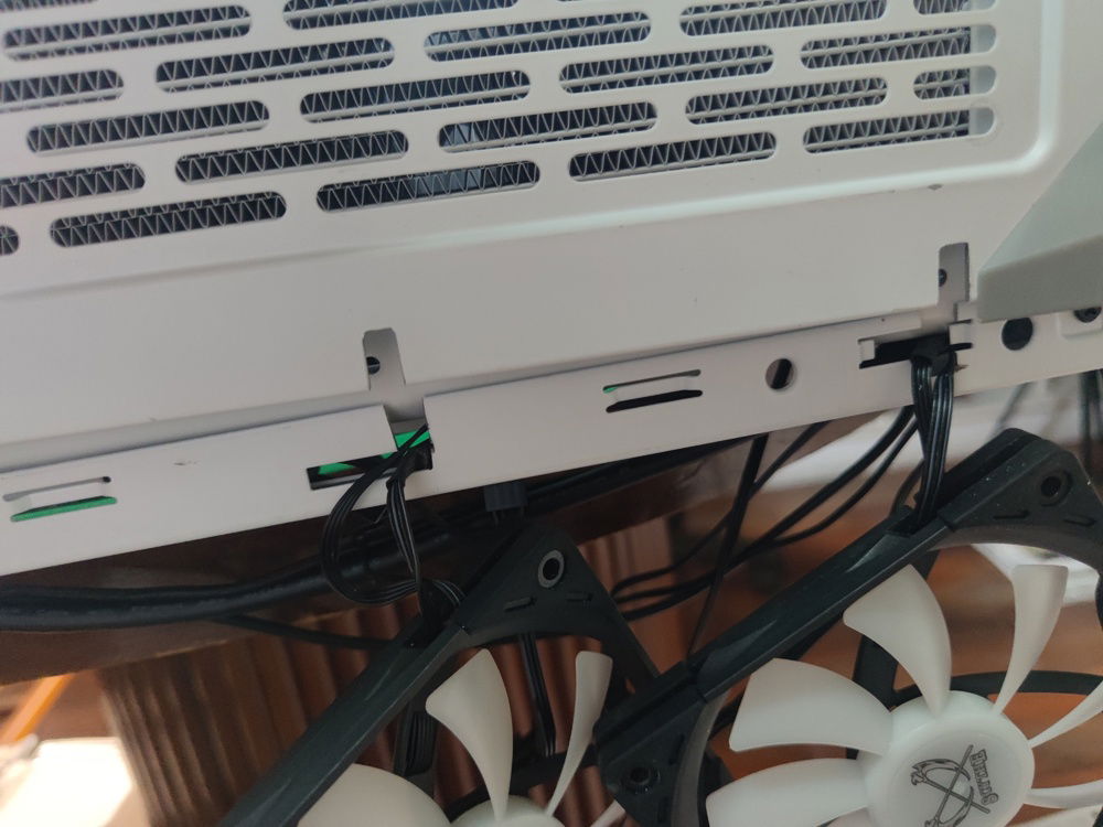 Slotting the bottom panel onto the support post locks in the external fan cables neatly.