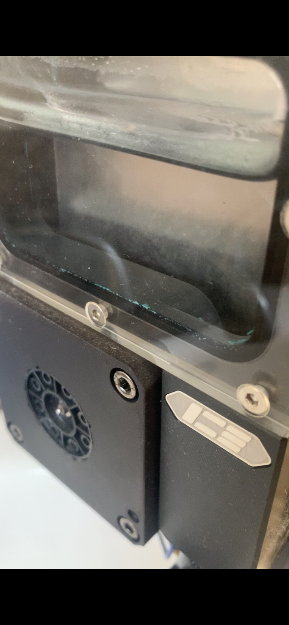 Before cleaning hard water build up on window. More green debris.