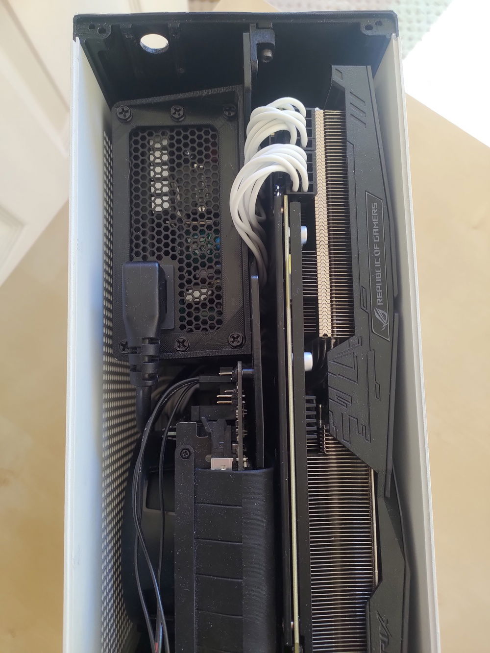 Unfortunately I couldn't get the original top panel cover back on since the strap hits the spine now. Might work if I 3d print a custom one

Custom 3d printed PSU mount can also be seen here