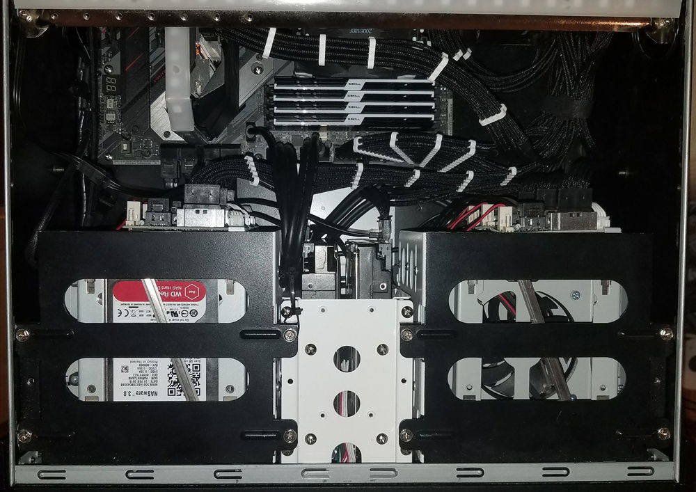When you have a case with no cable management, CableMod is a must. Sadly they stopped offering SATA Pro mods so I had comb the one stretching the width of the case myself. Down the road I plan to put two 40mm noctua fans behind the two surveillance drives in the middle.