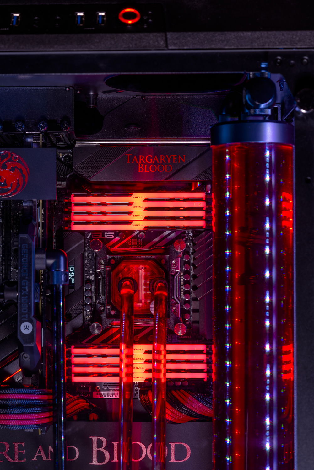 close up of the 128gb of ram, the painted part of the motherboard io cover, custom cables, painted heatsinks