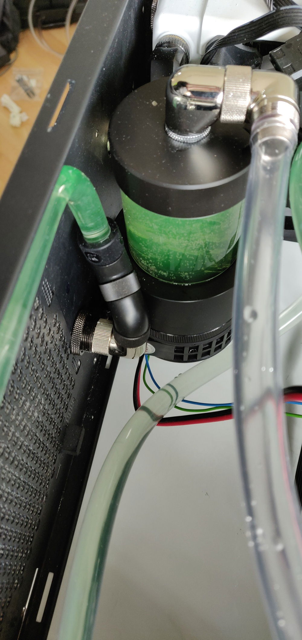 Bend goues around the PSU and up to the top radiator, all hidden behind the shroud and motherboard tray