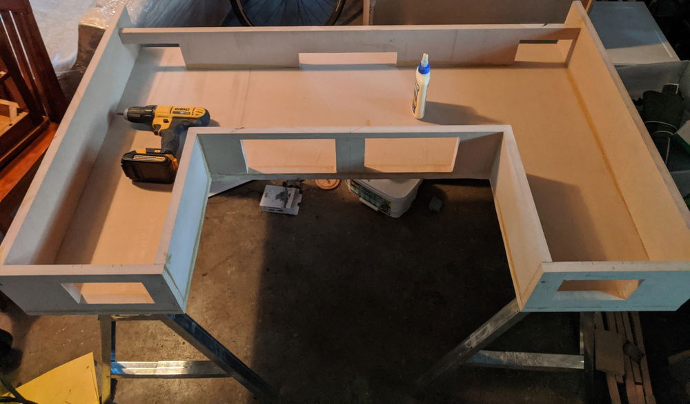 Holes cut in back wall for cables and PSUs.  Holes cut in middle for filtered intake fans.  Holes cut in front for the reservoirs.