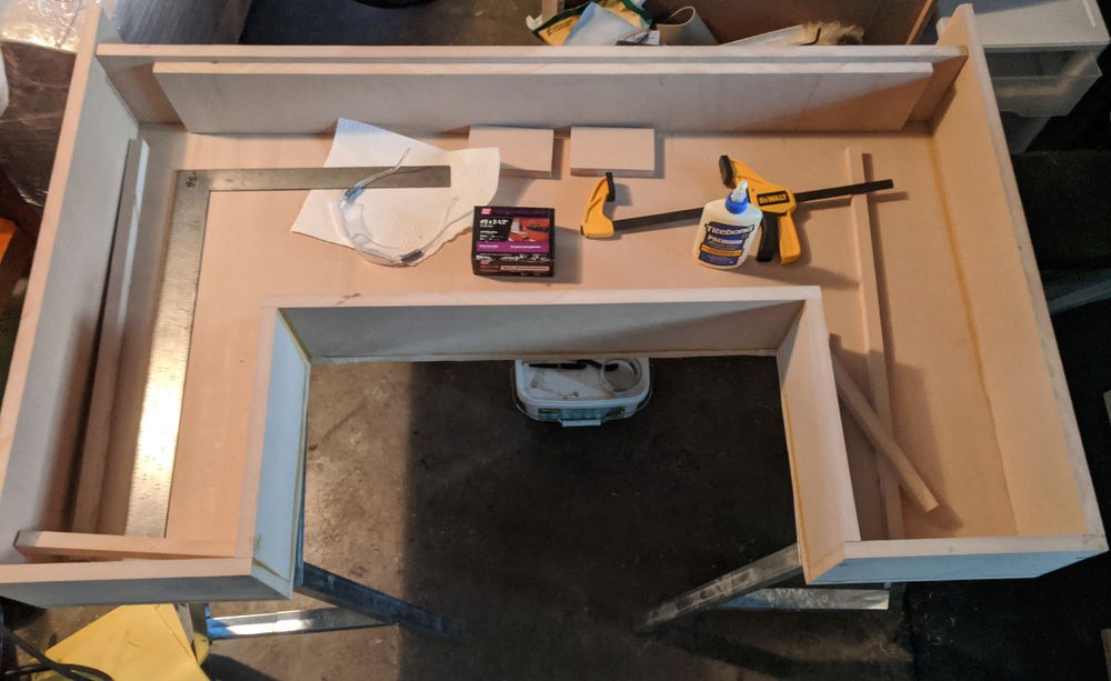 Front and side walls attached to the base and each other with wood glue and screws.