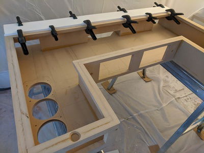 Monitor plate is being glued down to provide extra strength to the back as well as a raised portion for the glass sheet to butt up against.  Also, all the radiator holes have been drilled!