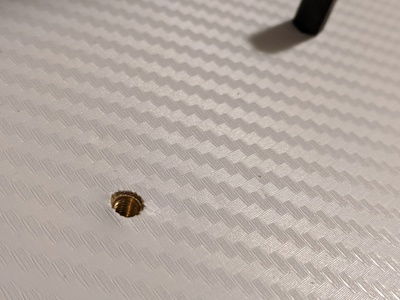 One of many holes drilled for threaded inserts to be used as mounting points for the acrylic plates.
