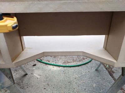 Hole cut for cables to go in and out of the case and reach the GPUs and motherboards.  The notch is to allow easier flow of the cables and a place for the tightening mechanism of the monitor mount to live.