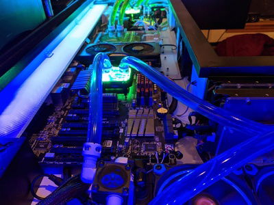 You can see the acrylic plate mounting system I designed here.  Each computer part is mounted to an acrylic plate with holes drilled specifically to fit it (not a big deal for ATX motherboards but the GPUs required some creative attachment points).  Those plates are then mounted to the desk itself with 1/2" standoffs.  This way when I upgrade parts in the future or form factors change I'll be able to adapt by just making new acrylic plates and won't have to drill into the desk again.