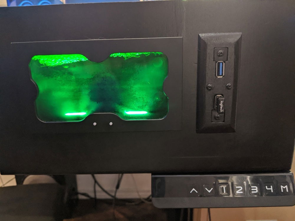 That's right, it can also be a standing desk at the push of a button!  Also, you can see my custom front I/O port here.  I made the face plate with Fusion 360 for the tool path, photoshop for the greyscale gradient, and a laser cutter to make the part.