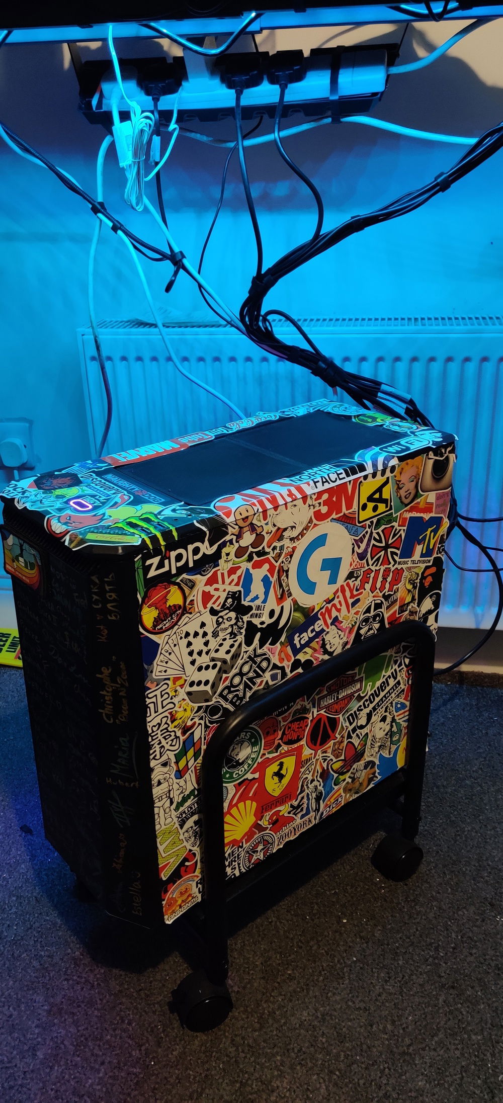 A collection of stickers all over the top and side of the PC