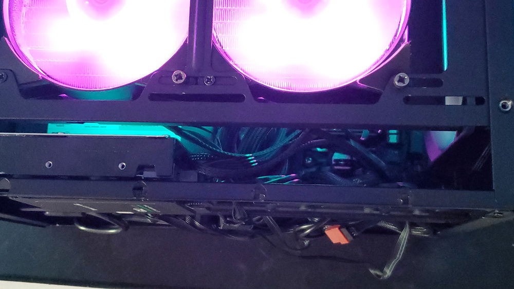 View inside the case trying to show the depth of the cables stuffed in the back of this case, one of the downsides of SFF.