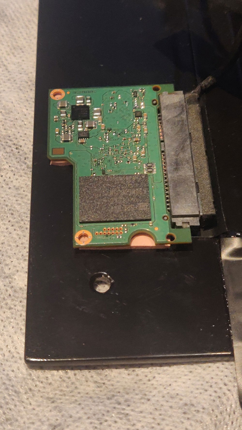 Place the ssd on the bottom of the frame to make the frame it's heatsink.